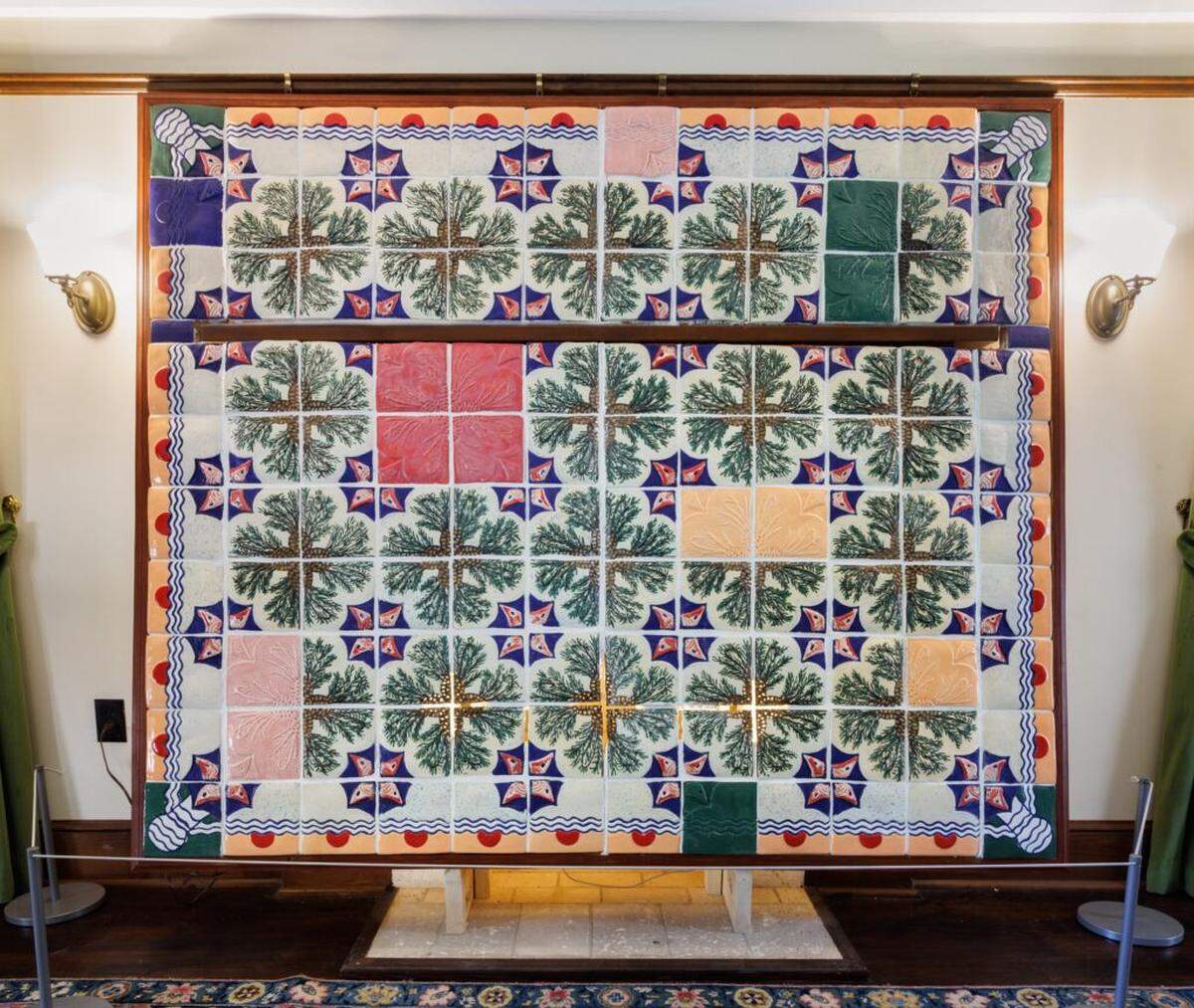 Artist Enma Saiz’s “Deering Tiles” installation at the Deering Estate. Saiz created holes in the coontie plant cones and left out the grout so that the glow of LED lights would come through the tiles at the level of the fire in a fireplace.