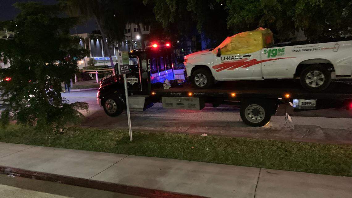 The U-Haul in which a suspected car burglar was shot and killed by Coral Gables police was towed away early Sunday night.
