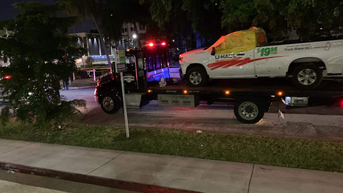 The U-Haul in which a suspected car burglar was shot and killed by Coral Gables police was towed away early Sunday night.