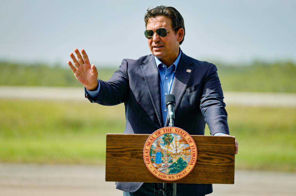 Governor Ron DeSantis speaks to reporters during a press conference as he stands on the airplane runway of Alligator Alcatraz in Ochopee , Florida on Friday, July 25, 2025. 