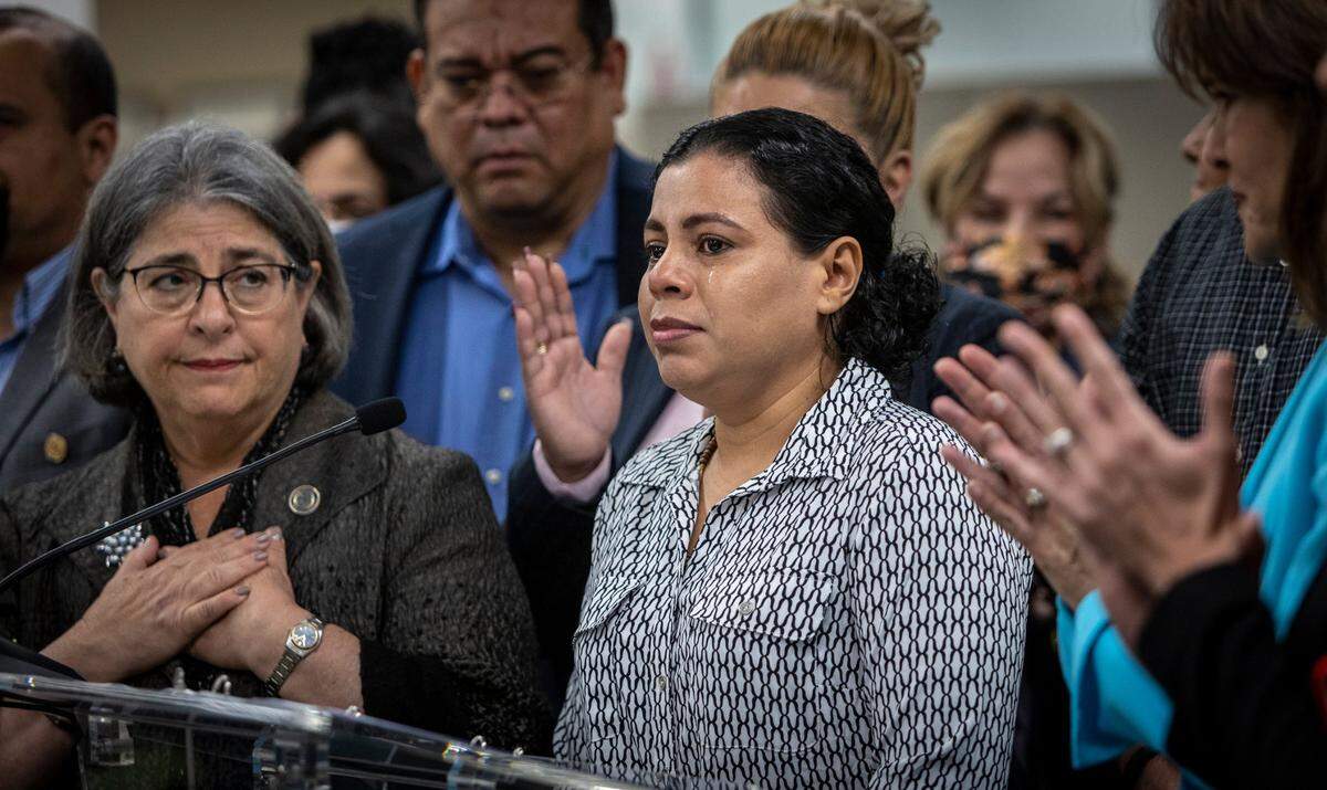 With tears in her eyes, former Nicaraguan political prisoner Maria José Martínez, center, receives a round of applause after she made a brief statement to the press in 2023 during a press conference at the Stephen P. Clark Government Center in downtown Miami.
