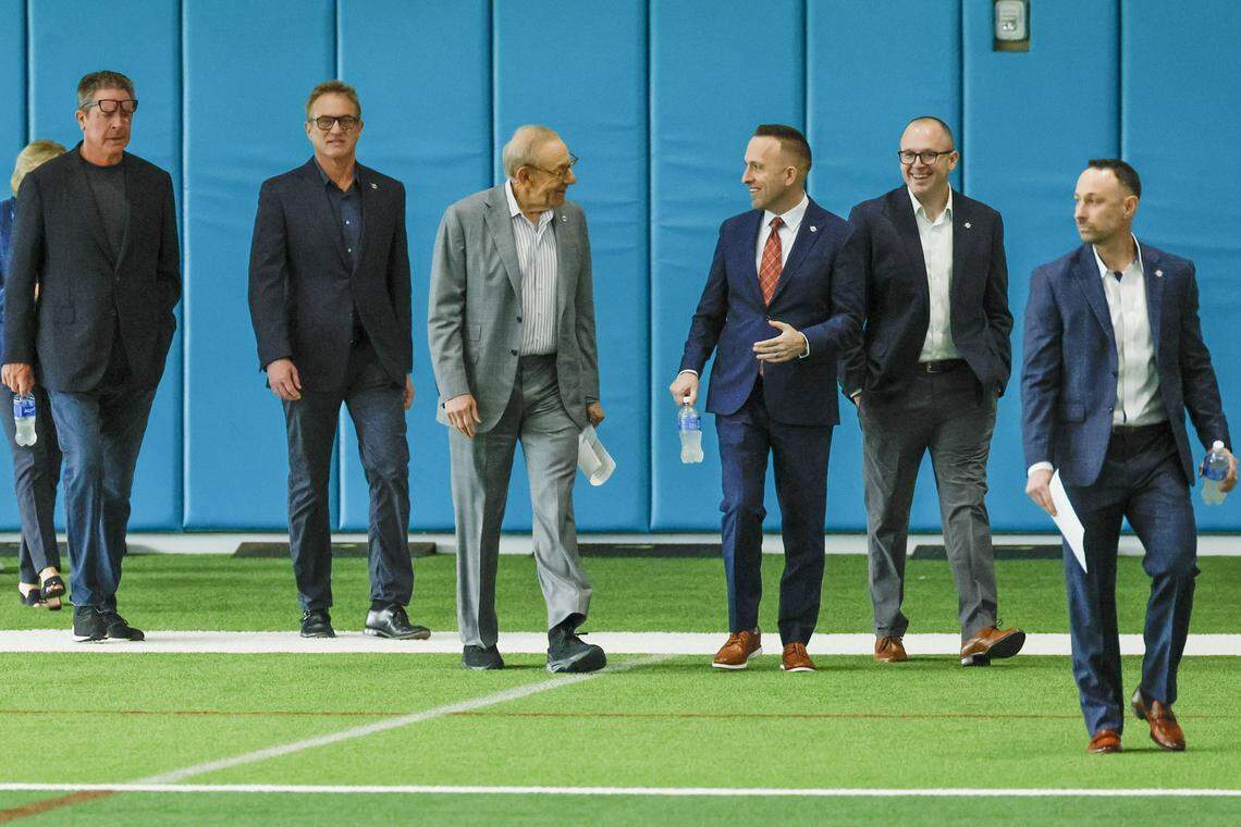 Miami Dolphins Chairman and Managing General Partner Stephen M. Ross, speaks with the new Head Coach Jeff Hafley, both at center, on arrival for a press conference at the Baptist Health Training Complex in Miami Gardens, Florida, on Thursday, January 22, 2026. 