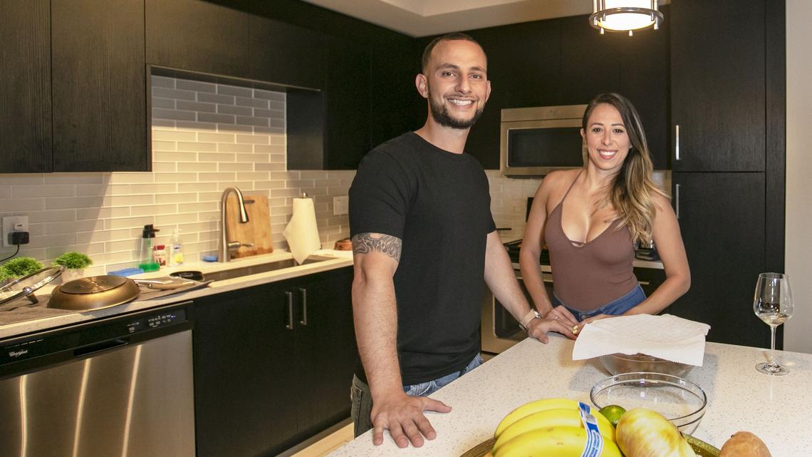Arturo Pena, 32, and his girlfriend Britany Del Cristo, 29, at their apartment in the Broadstone building in Miami, Florida, on Friday, June 14, 2019. They have held off on having kids to save money.