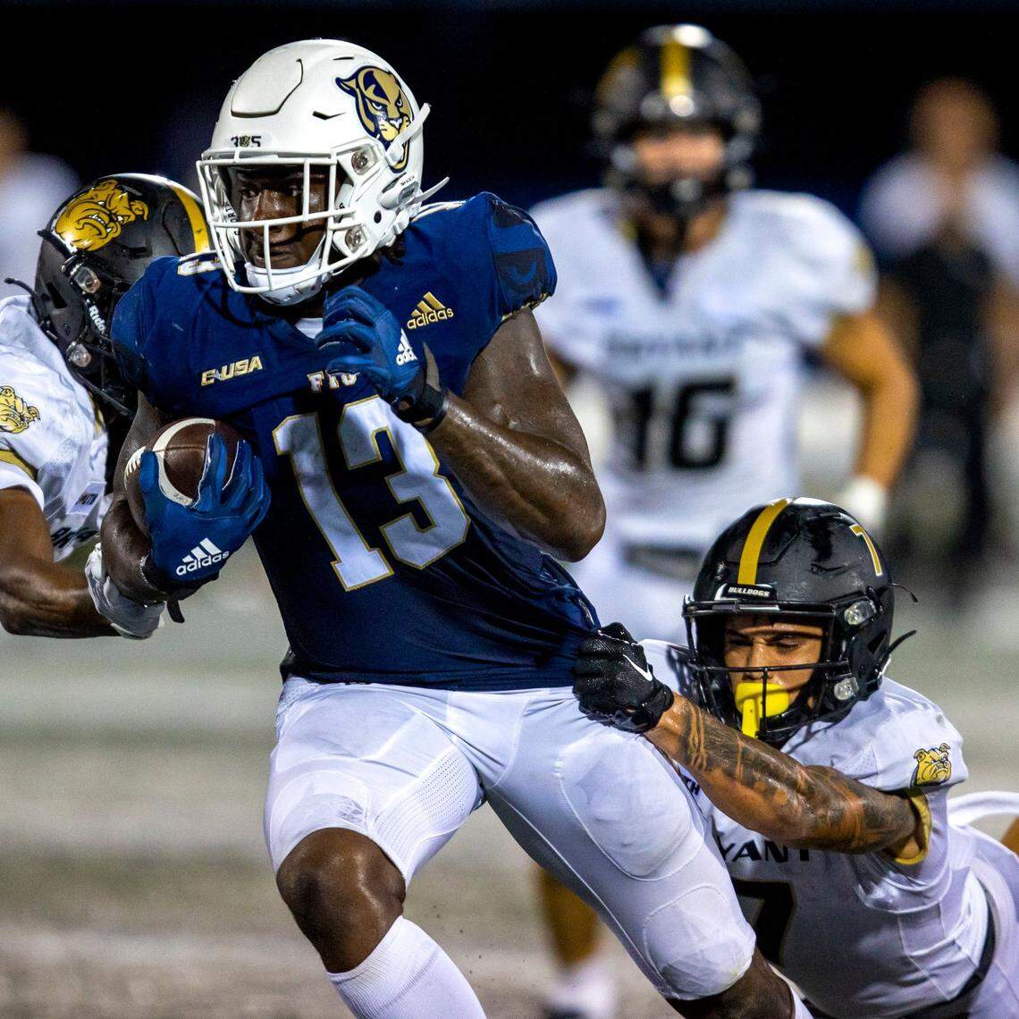 Florida International University tight end Rivaldo Fairweather (13) is tackled by Bryant University defensive back Jayvis Rayside (7) during an NCAA Conference USA football game at Riccardo Silva Stadium in Miami, Florida, on Thursday, September 1, 2022.