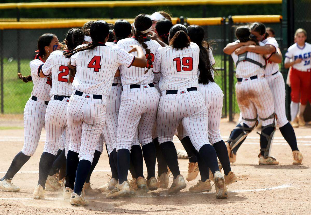Doral Academy players mob the field after recording the final out of the FHSAA Class 6A state softball championship game on Saturday at Solider’s Creek Park in Longwood. Doral defeated defending state champions Pace 1-0.