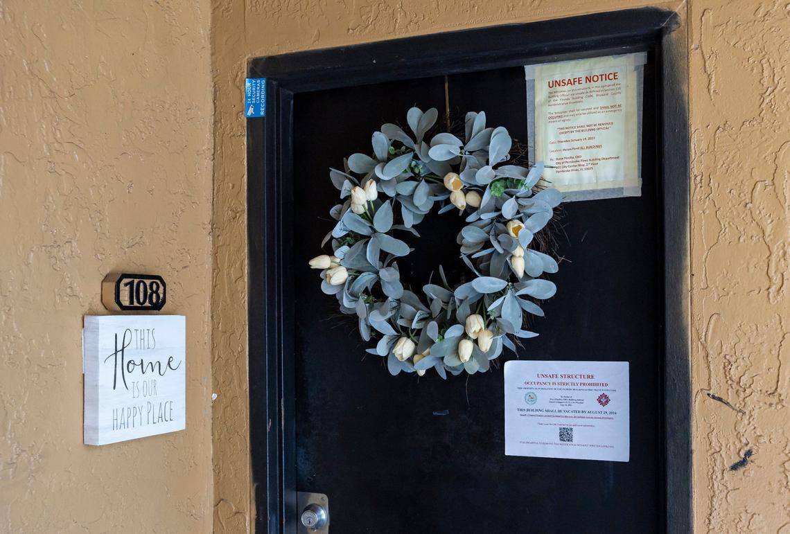 Notices hang from the entrance of a home in the Heron Pond complex on Wednesday, Aug. 7, 2024, in Pembroke Pines, Florida. City officials have alerted residents that they must vacate their homes by Aug. 29 after engineers deemed all 304 units spread across 19 buildings in the community unsafe for occupancy.