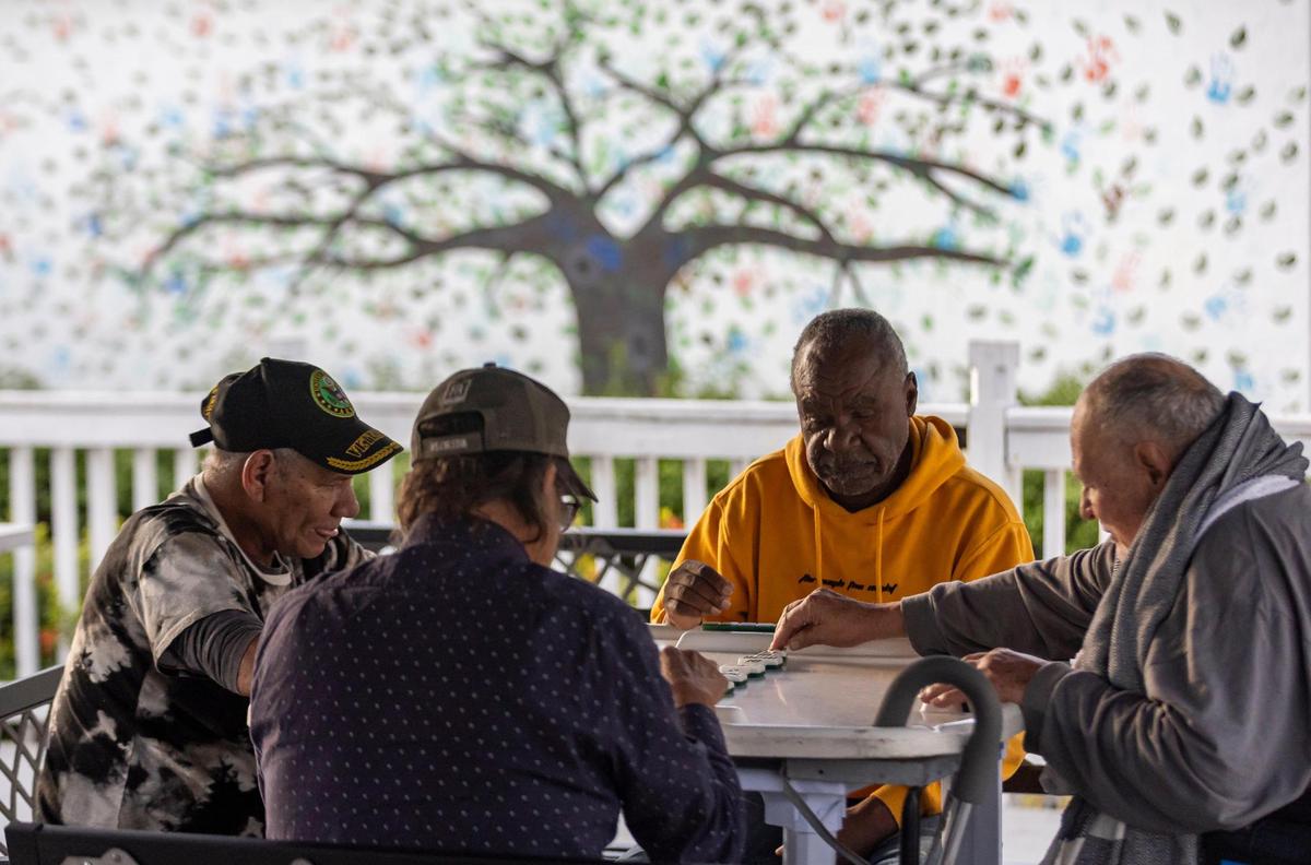 Residents at Mia Casa play dominoes on Thursday, Jan. 16, 2025, in North Miami, Florida. Mia Casa, owned by Miami-Dade County’s Homeless Trust, supports 120 homeless seniors aged 65 and older with shelter and assistance transitioning to permanent housing.