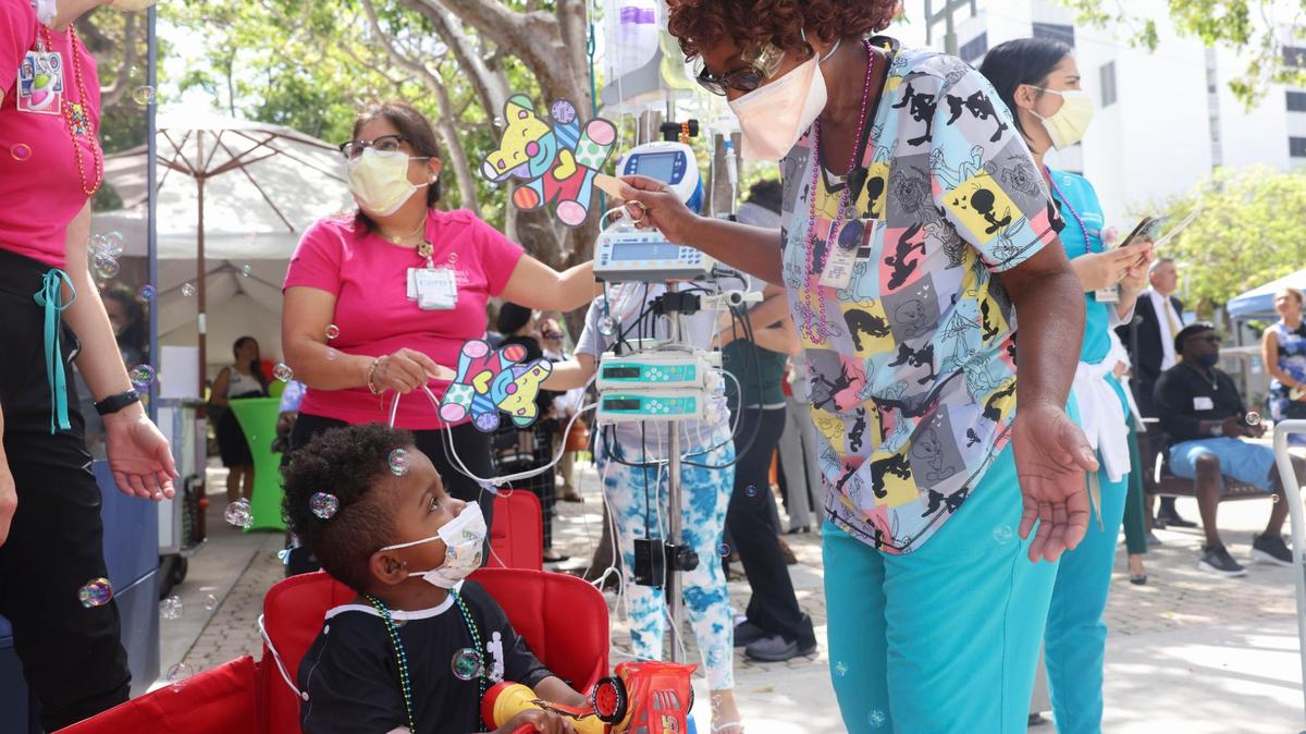 Larry, 5, left, and his nurse play with bubbles before a parade put on by Shriners Children’s Florida at Jackson Memorial Hospital on Friday, July 22, 2022. Jackson Health System, University of Miami Health and Shriners Children’s are partnering to open a new pediatric orthopedic center at Jackson.