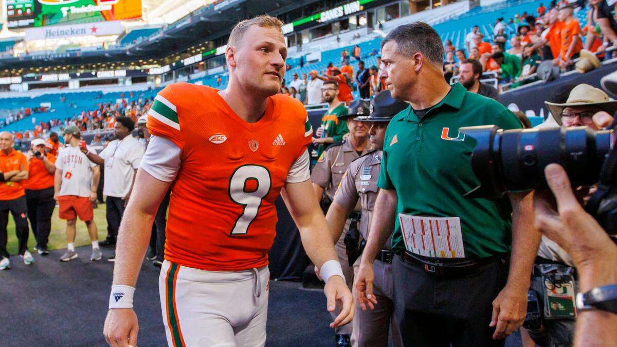 Miami Hurricanes quarterback Tyler Van Dyke (9) and head coach Mario Cristobal walk to the locker room after their 70-13 win over Bethune-Cookman Wildcats during an NCAA non conference football game at Hard Rock Stadium on Saturday, September 3, 2022 in Miami Gardens, Florida.