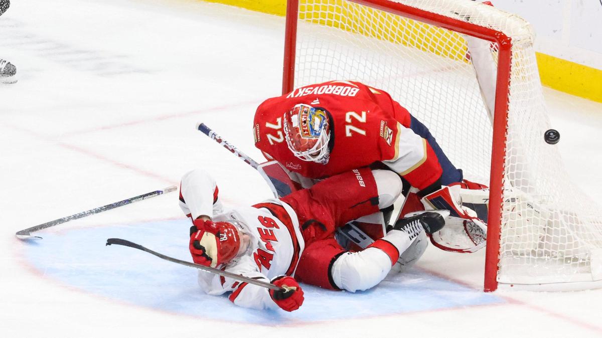 Carolina Hurricanes center Jesperi Kotkaniemi (82) slides into Florida Panthers goaltender Sergei Bobrovsky (72) during the third period of a game on Thursday, Jan. 2, 2025, at Amerant Bank Arena in Sunrise, Fla. The Panthers lost 3-1.