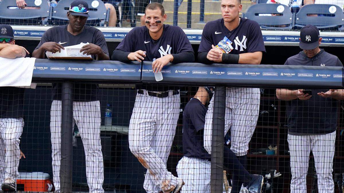 New York Yankees’ Anthony Rizzo, left, and right fielder Aaron Judge, right, watch from the dugout during a spring training baseball game against the Atlanta Braves, Saturday, April 2, 2022, in Tampa, Fla.