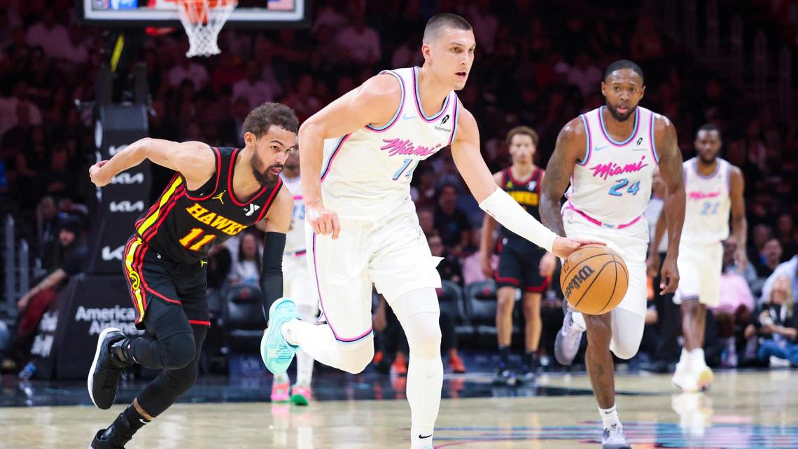 Miami Heat guard Tyler Herro (14) gets the ball from Atlanta Hawks guard Trae Young (11) during the first half of a game on Thursday, March 27, 2025, at the Kaseya Center in downtown Miami, Fla.