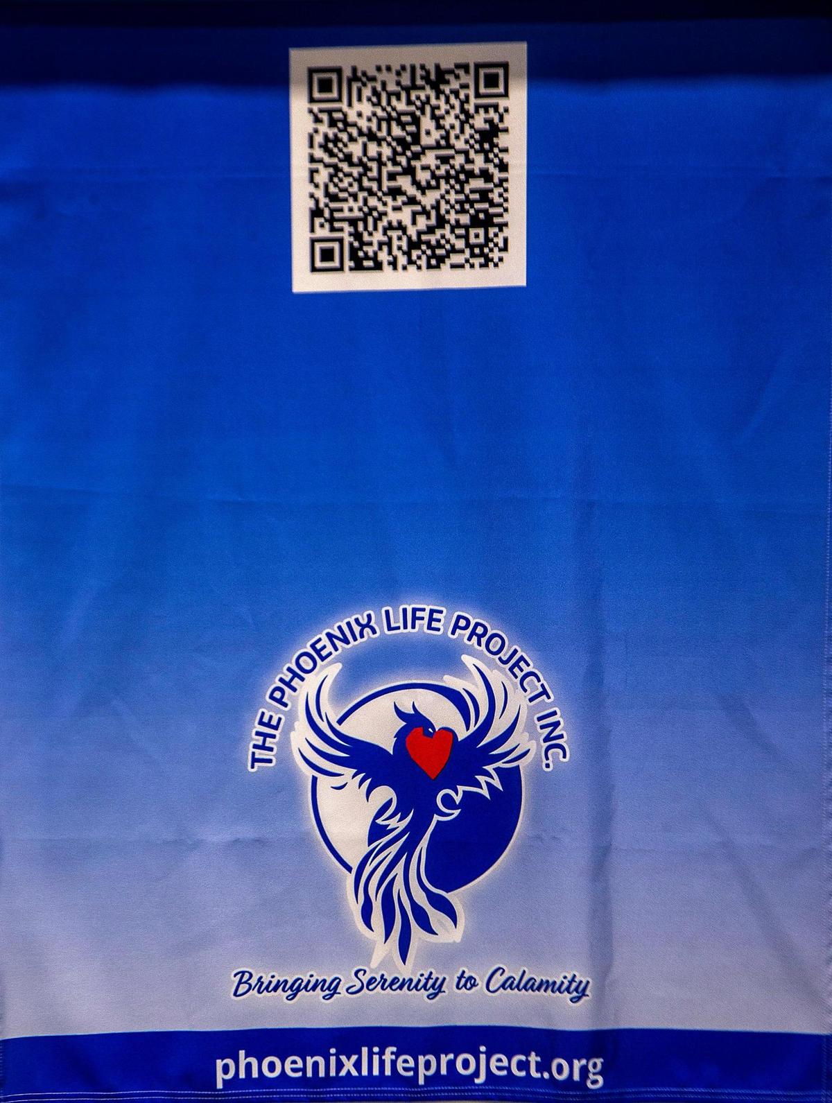 Banner of The Phoenix Life Project, a nonprofit created by Neil Handler in March 2022 after seeing how therapy helped his son Jonah Handler, one of only three survivors pulled from the rubble after the partial collapse of the Champlain Towers South condo on June 24, 2021. The Phoenix Life Project helps provide therapy for Surfside families and first responders.