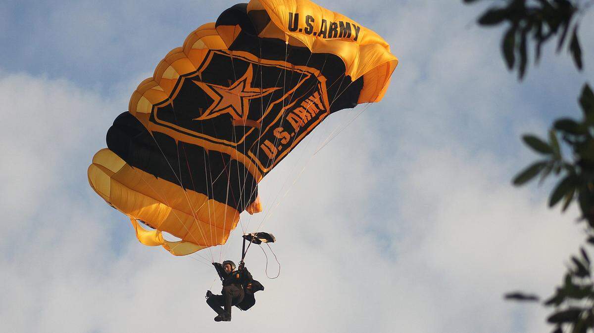 A member of the U.S. Army parachute team the Golden Knights descends into Losner Park in Homestead in February 2012.