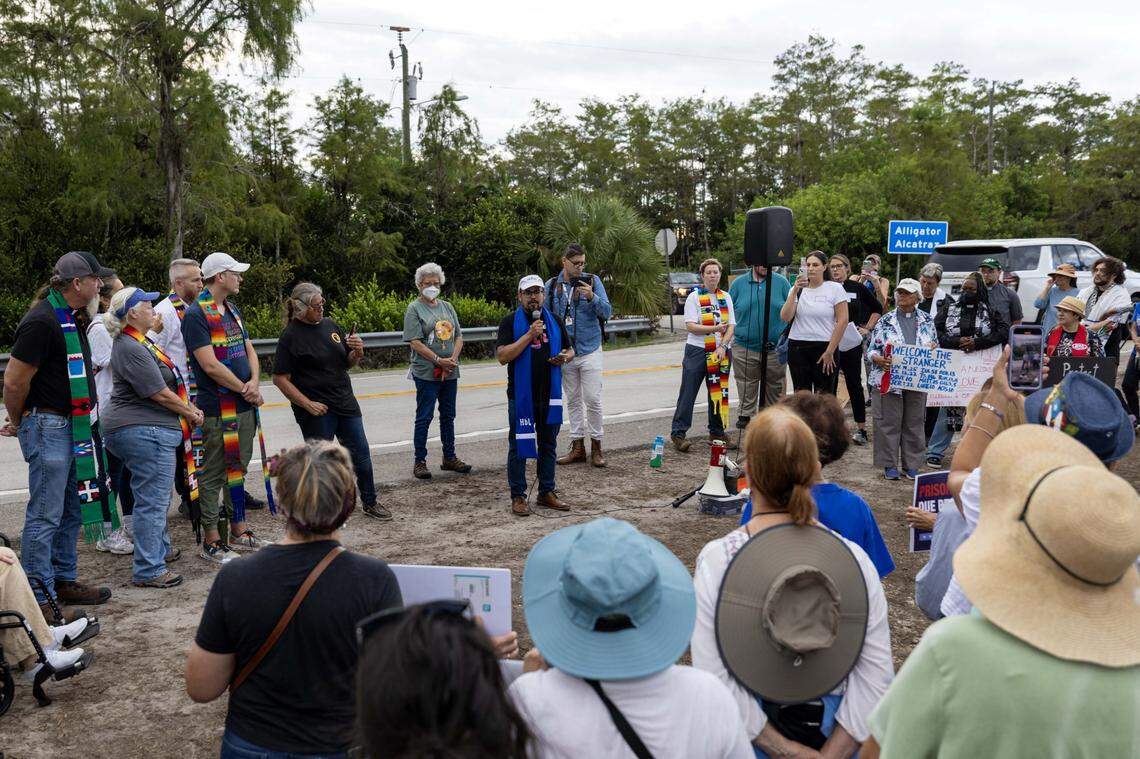 Pastor Juan Del Hierro from Unity on the Bay speaks to an interfaith group outside Alligator Alcatraz. The group of faith leaders and believers oppose the treatment of migrants and immigrant policies that they said defies their faith. 