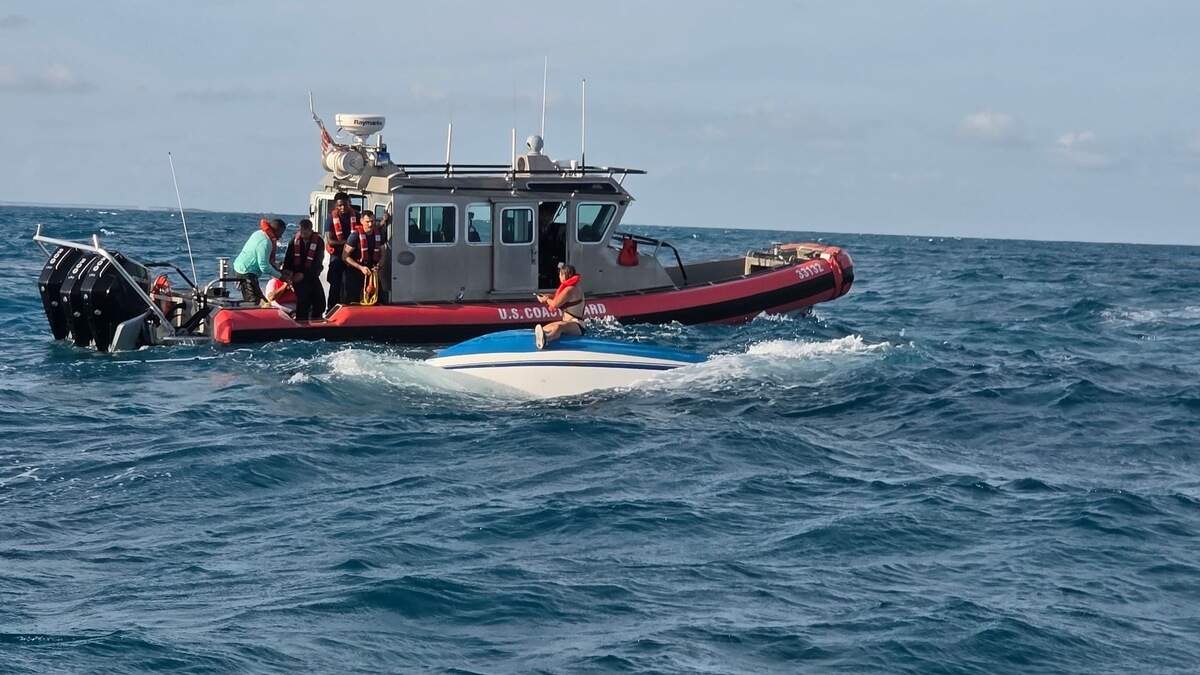 A Coast Guard Station Marathon boat crew pulls up to three boaters after their vessel capsized about five miles south of Little Palm Island Sunday, June 8, 2026. The boat crew transported the three boaters to Bahia Honda State Park with no injuries reported, the Coast Guard said.