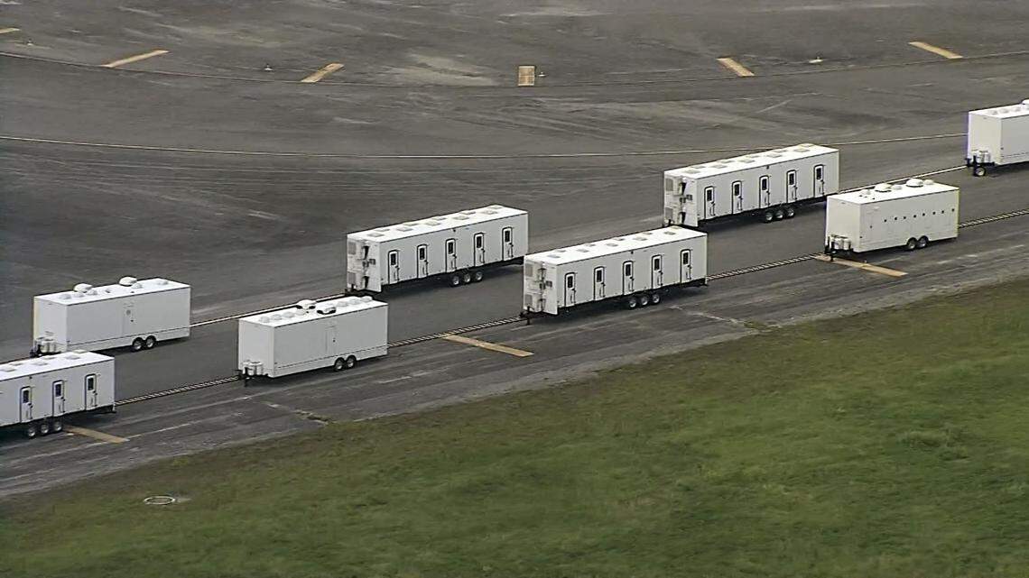 A runway at the former Dade Collier Training and Transition Airport is used for a row of trailers.