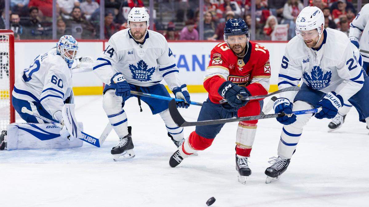 Florida Panthers center Sam Reinhart (13) fights for the puck against Toronto Maple Leafs defenseman Brandon Carlo (25) in the third period of Game 6 of a second-round Stanley Cup playoffs series at the Amerant Bank Arena on Friday, May 16, 2025, in Sunrise, Fla.