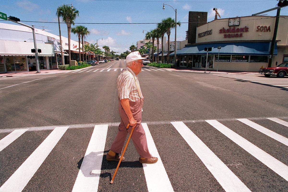 Bernard Laszlo, 89, walks across Harding avenue in the newly renovated business district of Surfside in June 1996.