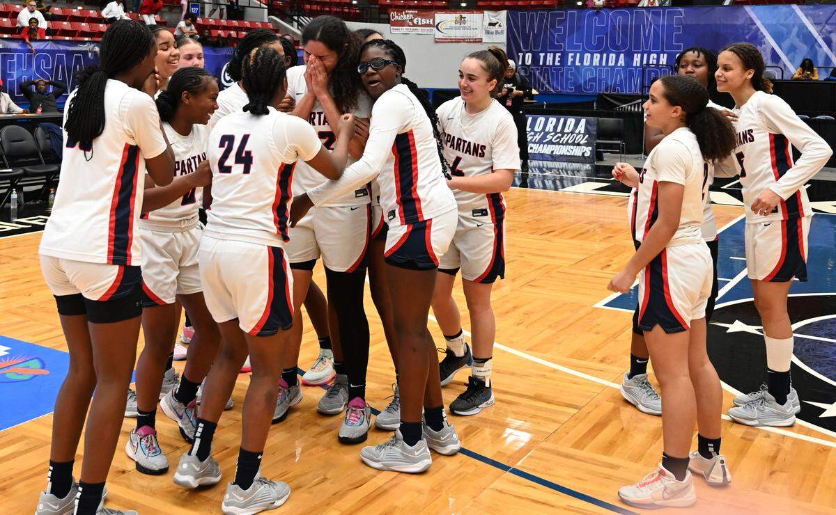 Miami Country Day players gather on the court to celebrate the team’s Class 3A state championship at the RP Funding Center in Lakeland on Friday.