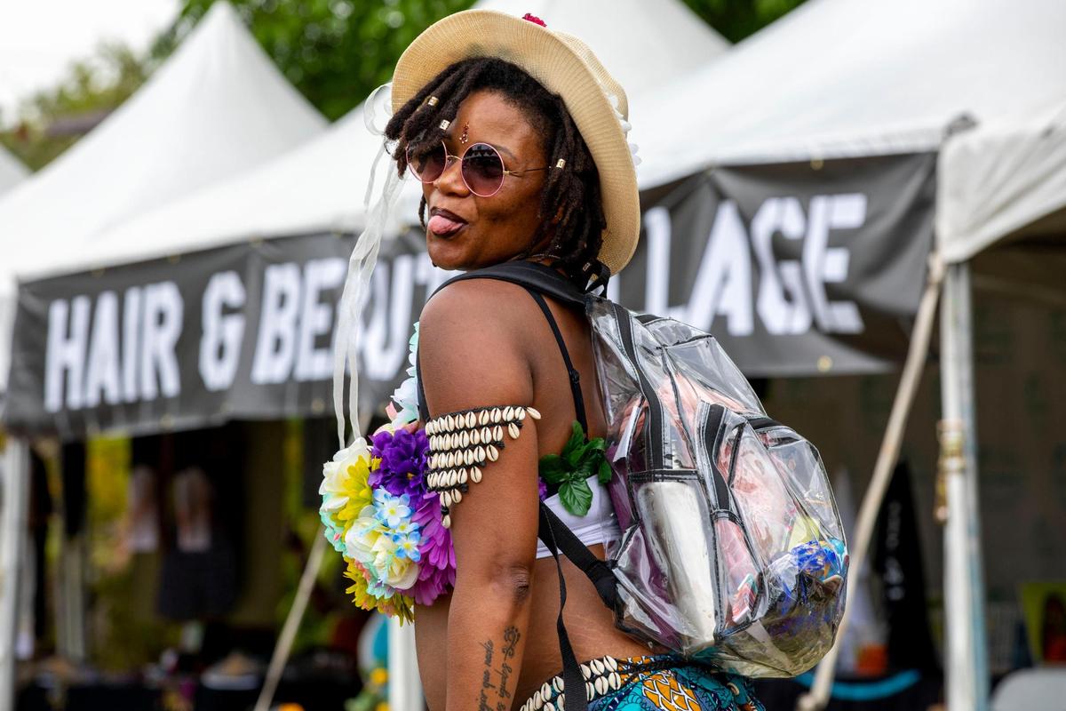 Miami resident Riane Taylor, 32, who is due in August with baby Lentel, dances to music during AFROPUNK music festival at The Urban in the Historic Overtown neighborhood of Miami, Florida, on Saturday, May 21, 2022.