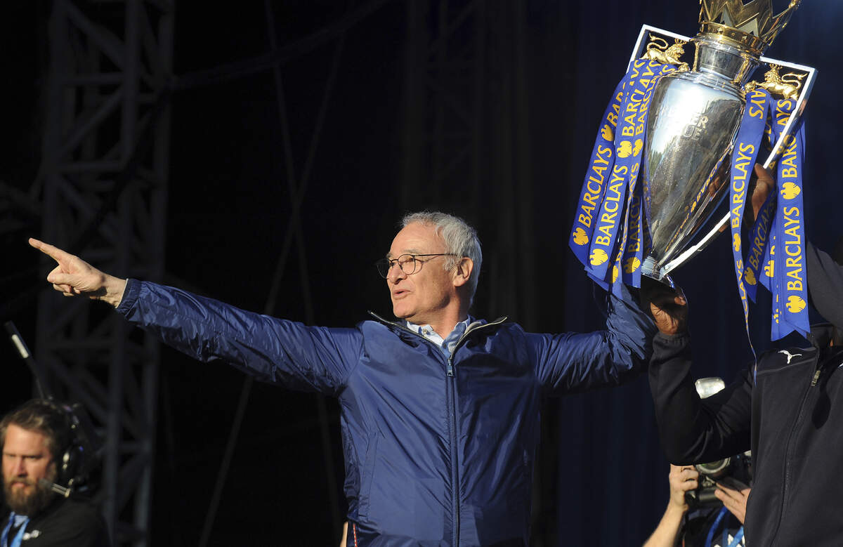 Leicester's manager Claudio Ranieri shows the Premier League Trophy to fans at Victoria Park during the victory parade to celebrate winning the English Premier league title in Leicester, England, in 2016.