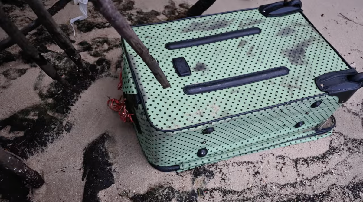 A green and black polka dot Charlie Sport bag.