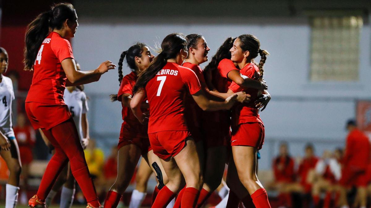 Doral Academy Olivia Vargas (12) celebrates with teammates after scoring a goal from the penalty spot against Coral Reef during the second half of a Region 4-7A quarterfinal playoff game at Doral Academy High School in Doral, Florida on Tuesday, February 7, 2023.