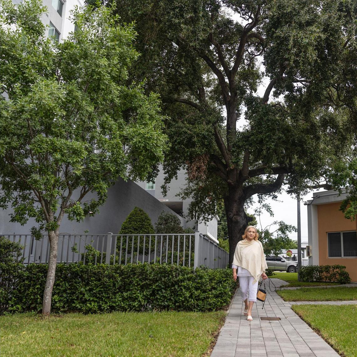 Zully Mar Vidal, resident of Wenski Groves — an affordable housing complex located in Allapattah — walks down the pathway where her apartment is located, next to her favorite tree in the neighborhood.