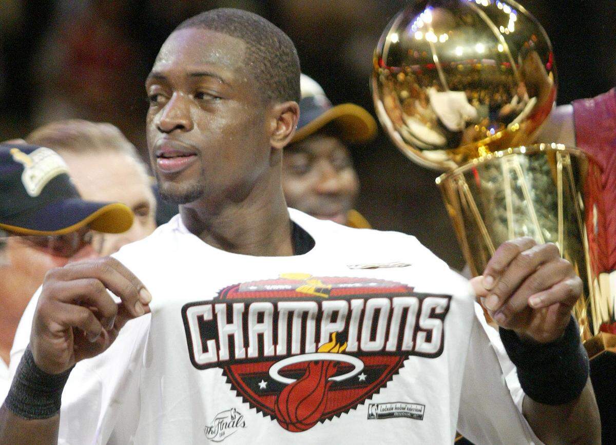 Dwyane Wade shows off the champions logo after the Heat won the 2006 NBA championship.