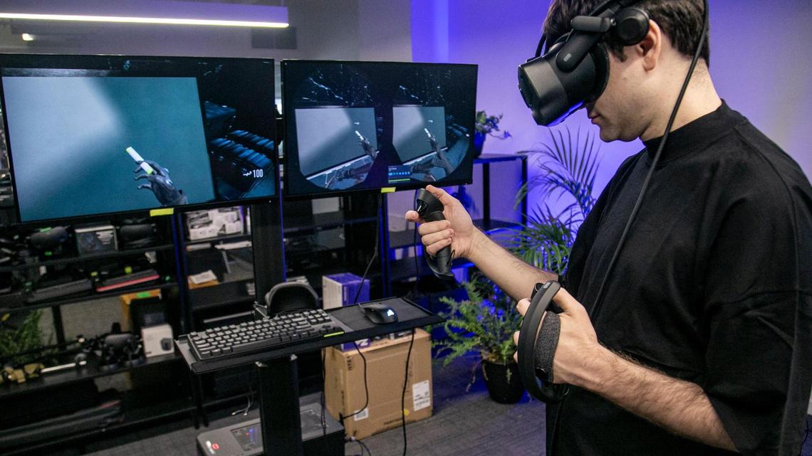 Albert Ovadia, co-founder, chief technology officer of AEXLAB, prepares to play Vail VR, a virtual reality video game in Miami on Dec. 24, 2021.