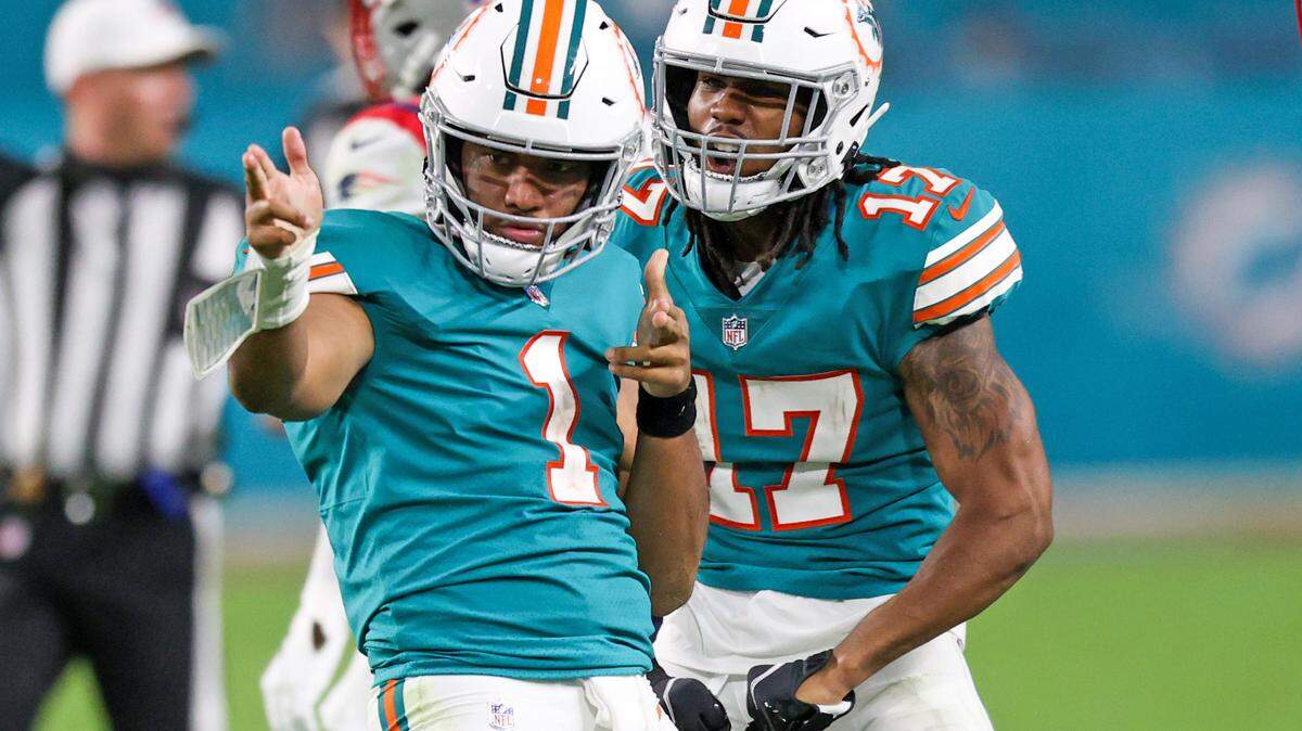 Miami Dolphins quarterback Tua Tagovailoa (1) celebrate with Dolphins wide receiver Jaylen Waddle (17) after running for a first down during the fourth quarter of an NFL football game against the New England Patriots at Hard Rock Stadium on Sunday, January 9, 2022 in Miami Gardens, Florida. (David Santiago Photo / Miami Herald)