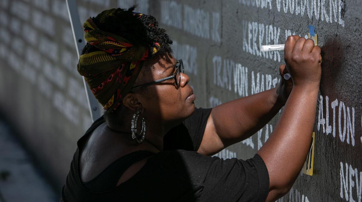 Miami, Florida, December 3, 2020- Artist / Activist Chire Regans works on a mural memorializing victims of gun violence that’s located at the Bakehouse Art Complex, 561 NW 32nd St, Miami, FL 33127