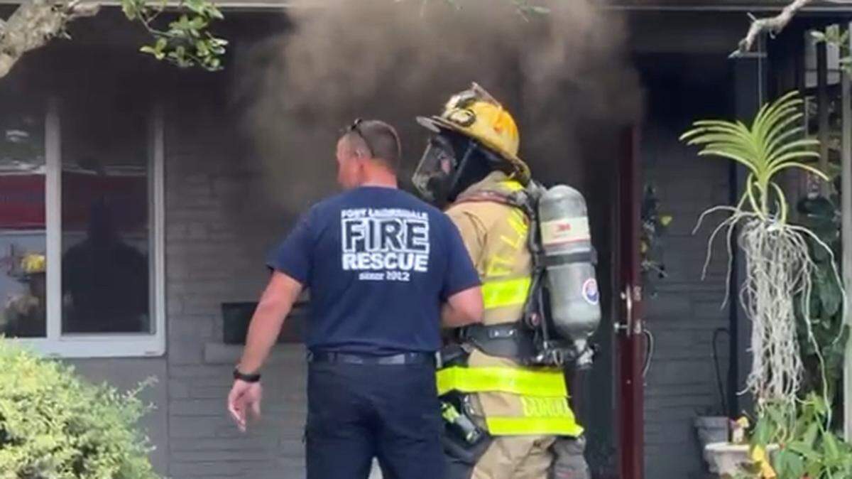 Fort Lauderdale firefighters battle a blaze at a Wilton Manors house Wednesday, April 23, 2025.