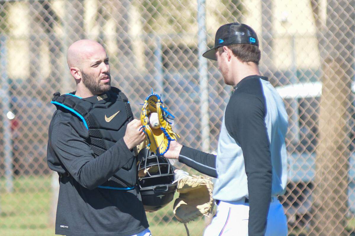 Miami Marlins catcher Jacob Stallings (left) and pitcher Trevor Rogers (right) talk after a bullpen session on Monday, Feb. 13, 2023, at the Roger Dean Chevrolet Stadium complex in Jupiter, Florida.