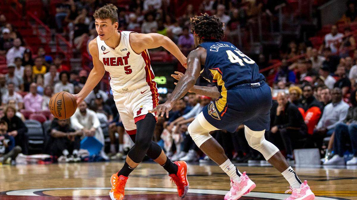 Miami Heat forward Nikola Jovic (5) drives on New Orleans Pelicans forward Zylan Cheatham (45) during the second half of an NBA preseason game in Downtown Miami on October 12, 2022.