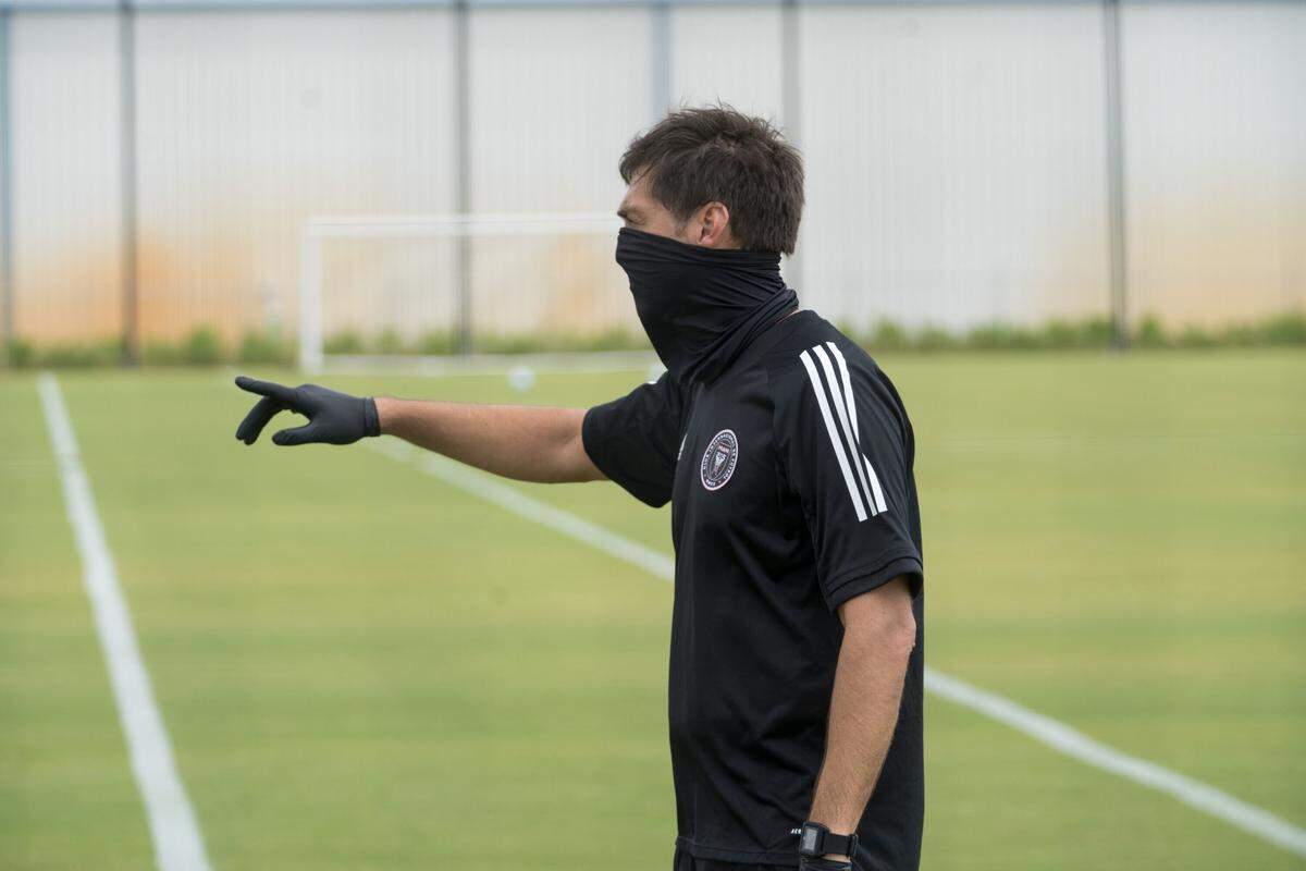 Inter Miami coach Diego Alonso wears a face mask as he leads individual workouts at the team’s Fort Lauderdale training facility.
