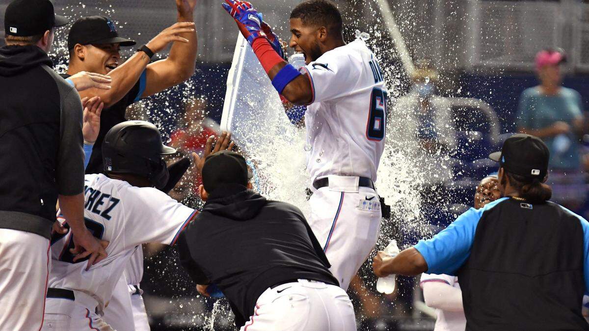 Miami Marlins’ Lewin Diaz, center, celebrates with teammates after hitting a two-run walkoff home run against the Pittsburgh Pirates in the 10th inning of a baseball game, Sunday, Sept. 19, 2021, in Miami. (AP Photo/Jim Rassol)