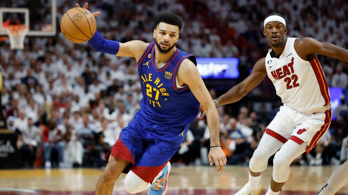 Denver Nuggets guard Jamal Murray (27) drives to the basket as Miami Heat forward Jimmy Butler (22) gives chase during the first half of Game 3 of the NBA Finals at the Kaseya Center in Miami on Wednesday, June 7, 2023.