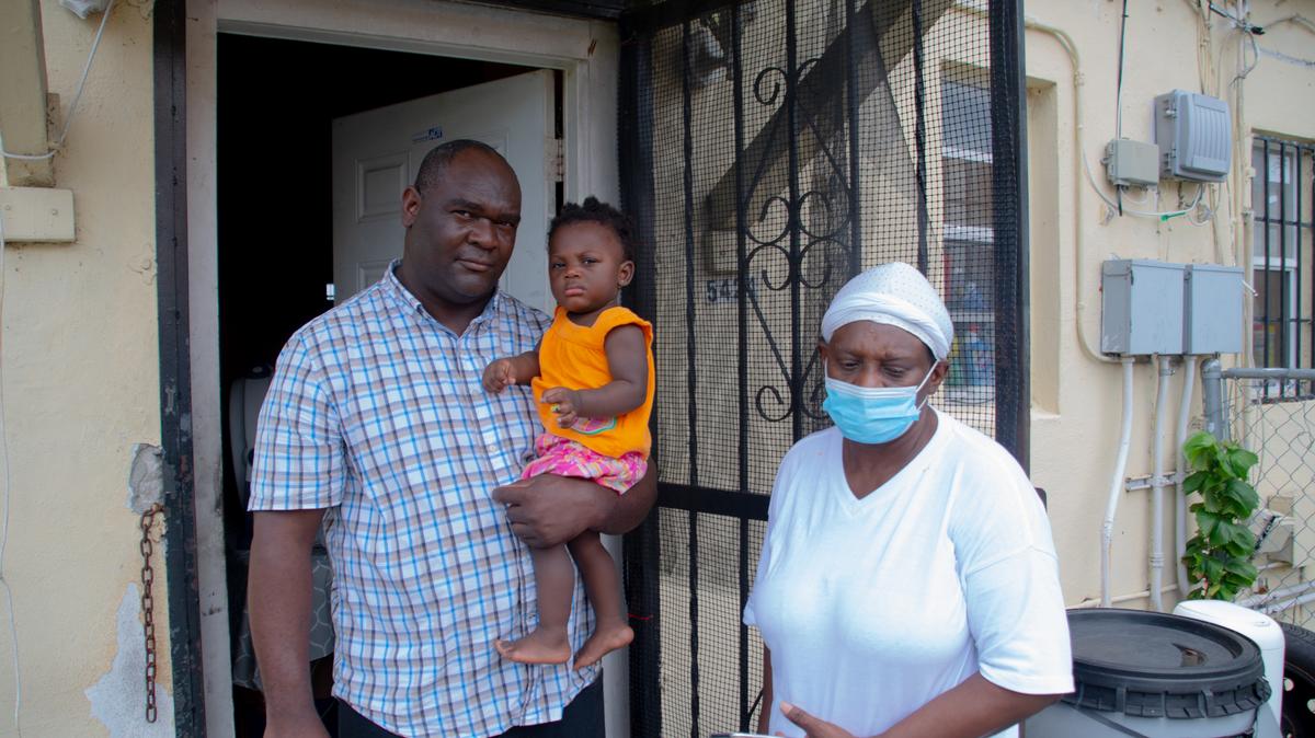 Robinson Pierre, 45, the uncle of Precious Paraison, who was killed in a 60-shot fusillade in Miami Shores early Thursday morning, June 18, 2020, holds her one-year-old daughter, Kiki Paraison, next to Precious Paraison’s grandmother, Kimanie Alicia Paraison.