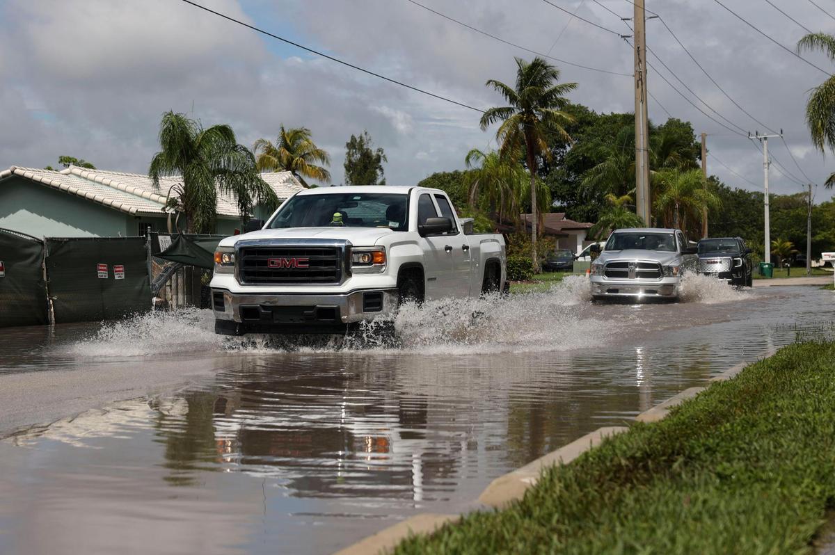 Larger vehicles drive down Southwest 198th Street on Tuesday, June 7, 2022, in Cutler Bay following the weekend storms.