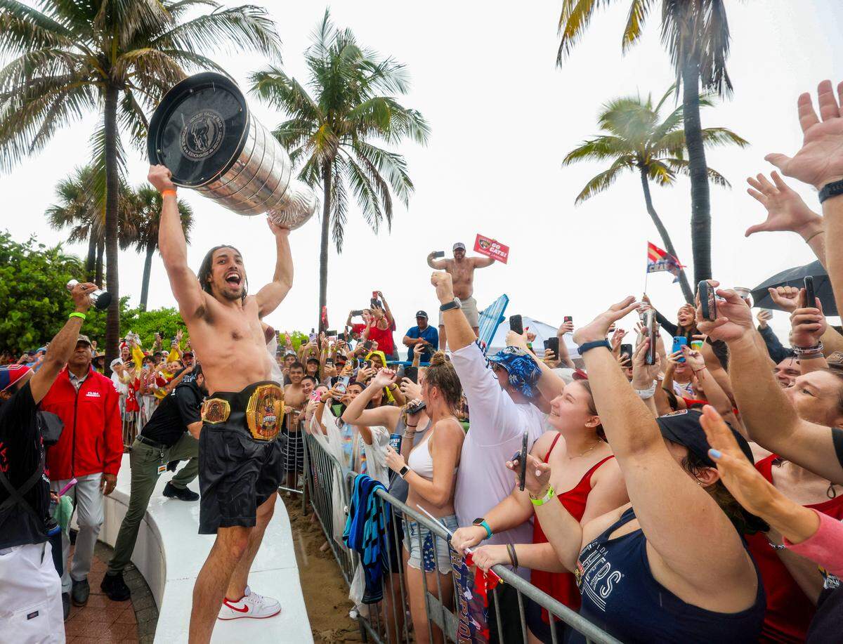 Florida Panthers left wing Ryan Lomberg lifts the Stanley Cup as fans cheers during the Florida Panthers victory parade before the Stanley Cup victory parade at Fort Lauderdale Beach on Tuesday, June 30, 2024 in Fort Lauderdale.&nbsp;