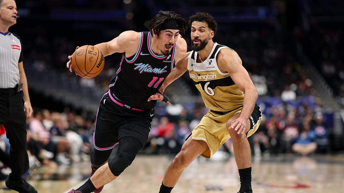 Jaime Jaquez Jr. #11 of the Miami Heat goes to the basket against Anthony Gill #16 of the Washington Wizards during the first half at Capital One Arena on April 10, 2026 in Washington, DC.
