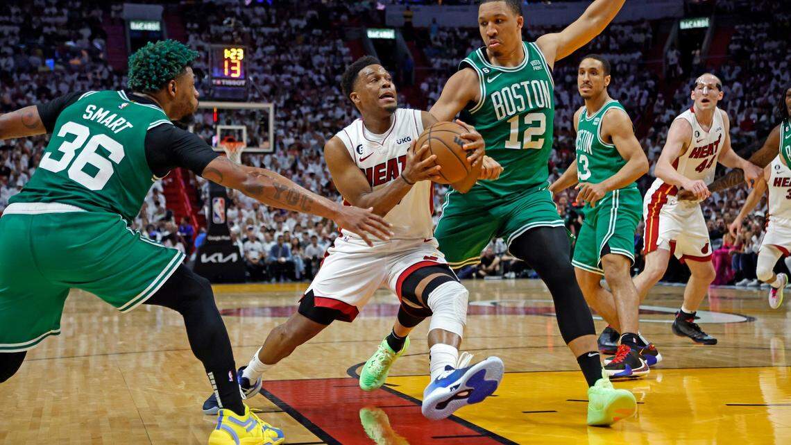 Miami Heat guard Kyle Lowry (7) drives to the basket as Boston Celtics guard Marcus Smart (36) and Boston Celtics forward Grant Williams (12) defend in the second half in Game 4 of the NBA Eastern Conference Finals at the Kaseya Center in Miami on Tuesday, May 23, 2023.
