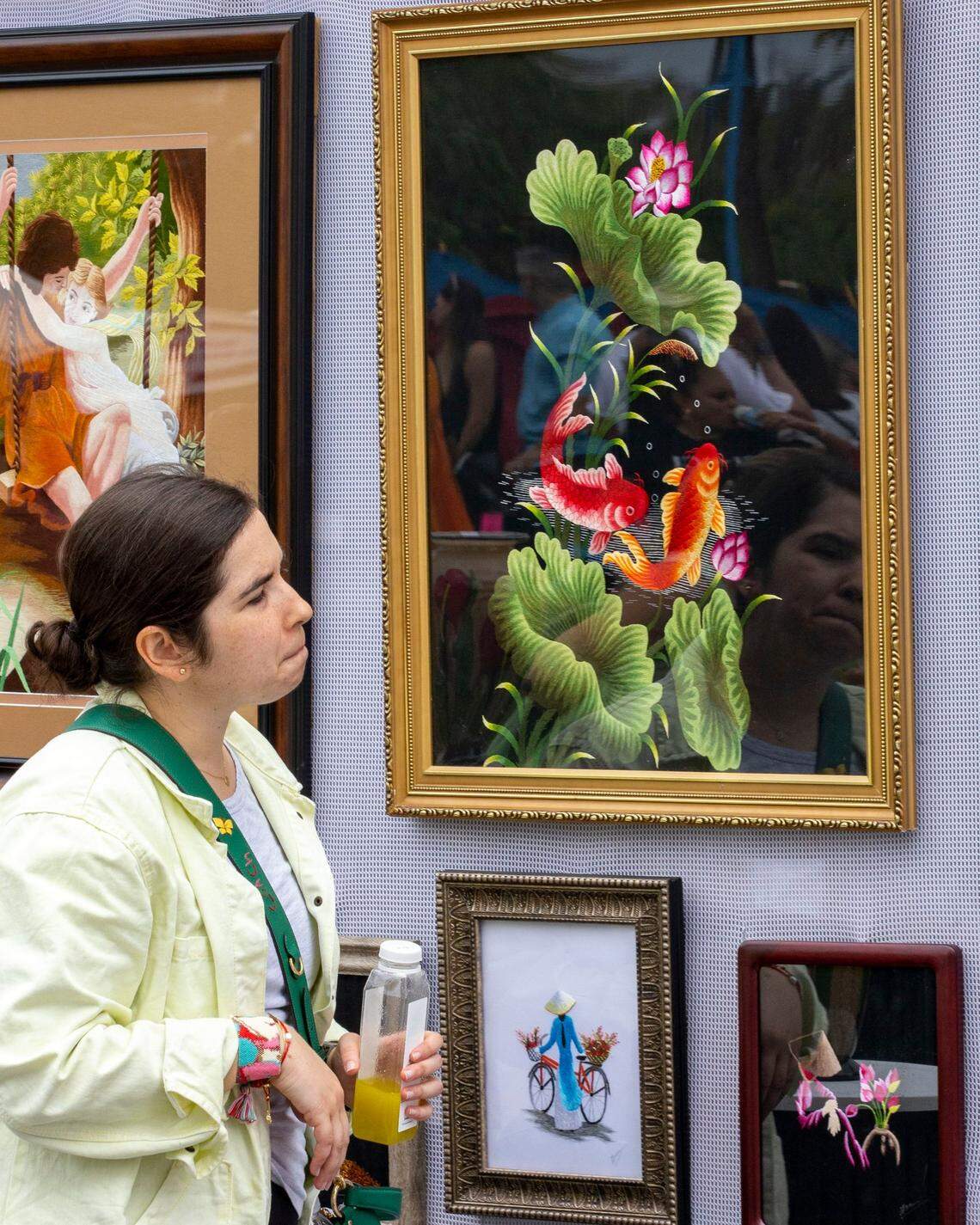 A festivalgoer checks out a booth during the 2022 Coconut Grove Arts Festival.