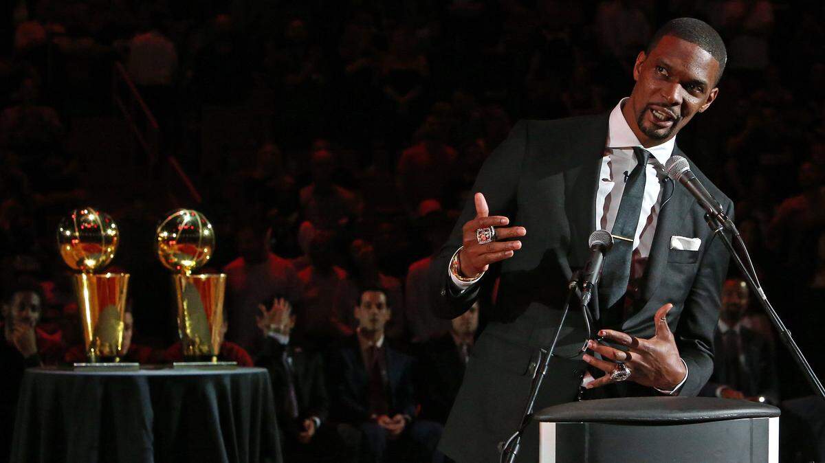 Former Miami Heat forward Chris Bosh speaks during a ceremony to retire his number at halftime of an NBA basketball game against the Orlando Magic at AmericanAirlines Arena on March 26, 2019 in Miami.