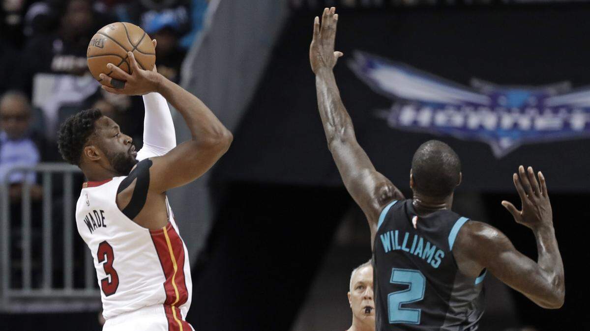 Miami Heat’s Dwyane Wade (3) shoots over Charlotte Hornets’ Marvin Williams (2) during the first half of an NBA basketball game in Charlotte, N.C., Wednesday, March 6, 2019. (AP Photo/Chuck Burton)