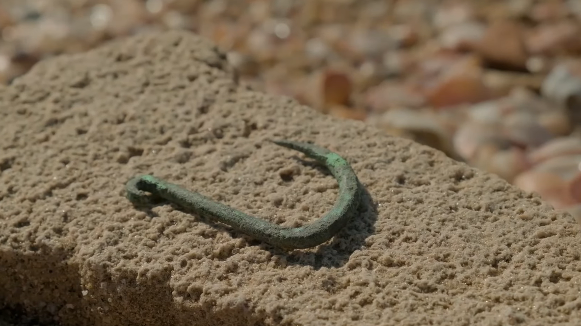 Archaeologists uncovered “oldest known” copper fish hook in Ashkelon, its large size indicates it was used for shark fishing, experts said.