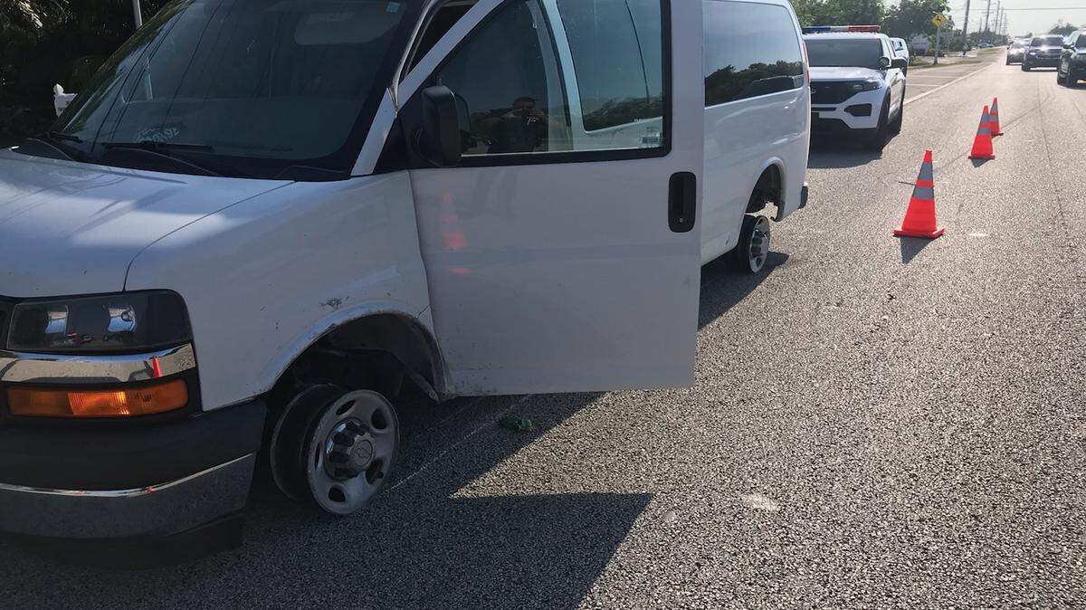 A Chevrolet van with no tires on its rims is parked on the side of U.S. 1 near mile marker 30 Tuesday, April 25, 2023. Monroe County sheriff’s deputies say the van was reported stolen earlier in the day from Key West.