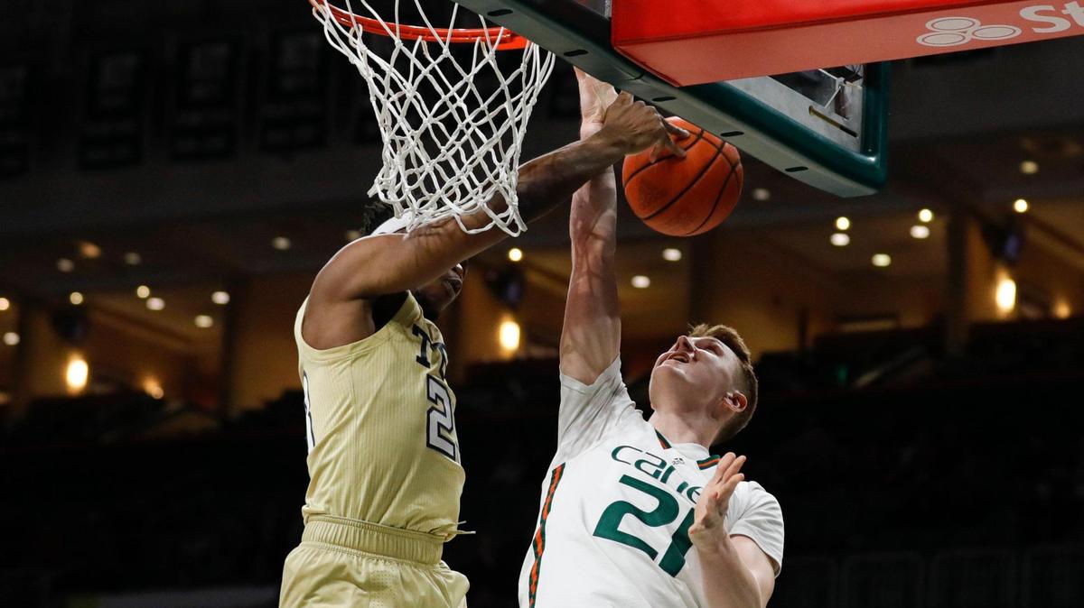 Georgia Tech Yellow Jackets forward Jordan Meka (23) blocks a shot by Miami Hurricanes forward Sam Waardenburg (21) during the first half of a basketball game at the Watsco Center in Coral Gables, Florida on Wednesday, February 9, 2022.